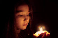 Sabian Symbol for Scorpio 4: A youth holding a lighted candle (in a devout ritual).